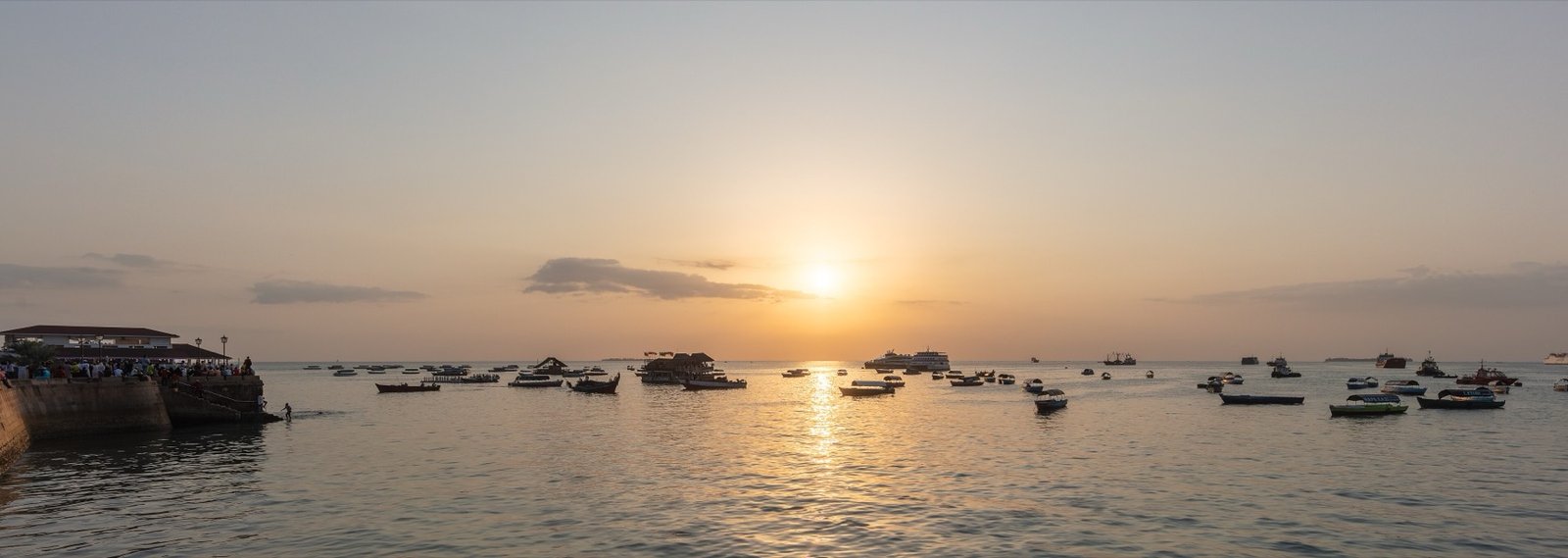 Dhows moored off Stone Town harbour at sunset